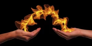 Healing fire jumps between a pair of hands.